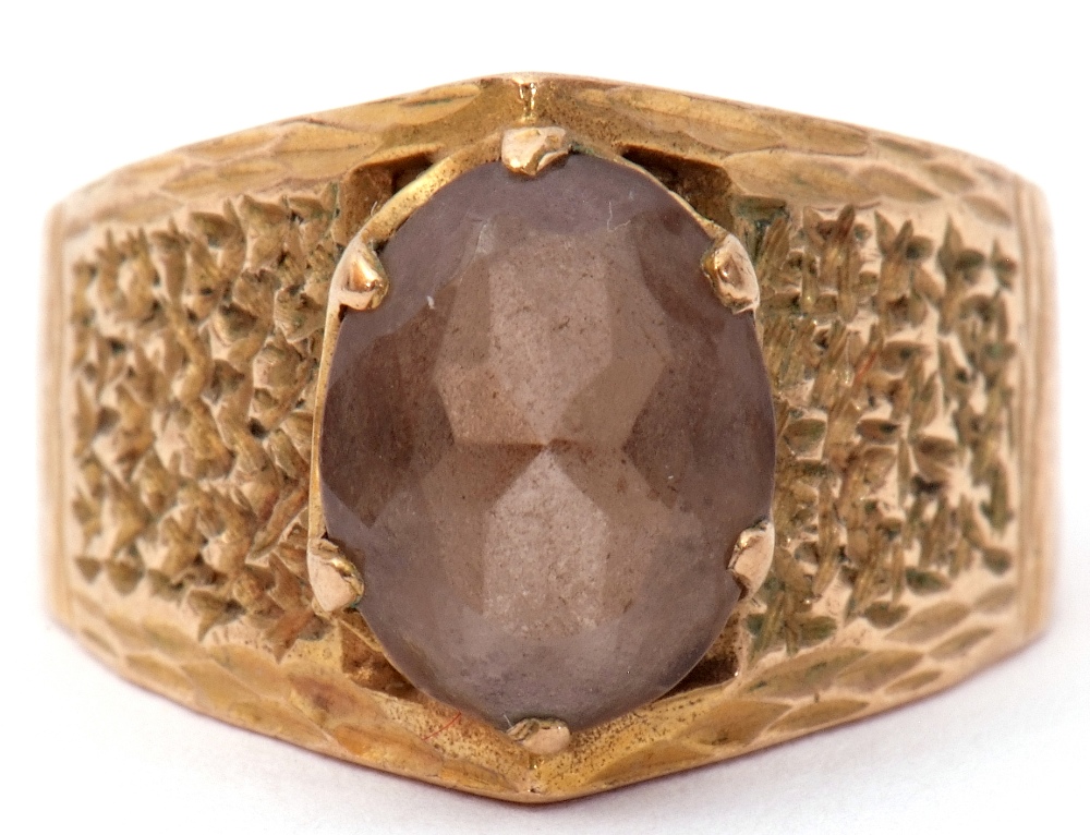 9ct gold and smoky quartz ring, the oval faceted smoky quartz in a coronet setting raised between