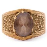 9ct gold and smoky quartz ring, the oval faceted smoky quartz in a coronet setting raised between