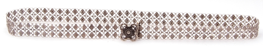 Chinese style white metal belt comprising small circular links decorated with chased geometric