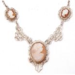 Vintage white metal filigree and cameo necklace, featuring three graduated carved cameos depicting