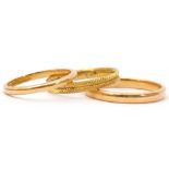 Mixed Lot: two 22ct gold wedding rings of plain polished design, 6.6gms, together with a gilt
