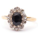 18ct gold sapphire and diamond cluster ring, the oval faceted dark sapphire set within 10 small