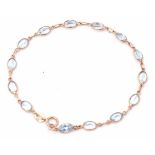 Modern 9ct gold bracelet featuring 14 oval faceted pale blue pastes, 19cm long