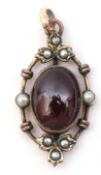 Victorian gilt metal, garnet and seed pearl set pendant, the cabochon oval shaped garnet in cut down