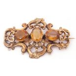 Large antique citrine three stone brooch, the oval cut stones claw set in cut down settings,