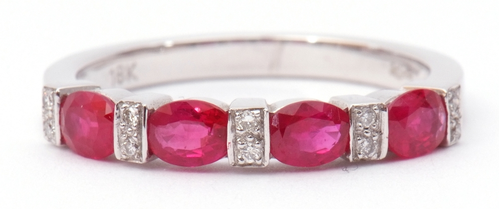 Modern ruby and diamond half-hoop ring, a design featuring 4 oval faceted rubies between 5 pairs