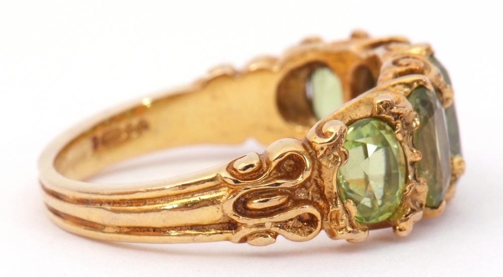 9ct gold five stone peridot ring, featuring five graduated oval cut peridots, claw set in carved - Image 5 of 8