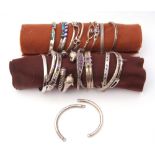 Twenty one various white metal hinge and torque style bracelets and some bangles with inlaid and