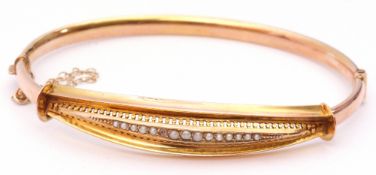 9ct gold and seed pearl hinged bracelet, the Etruscan style front pierced and engraved and set