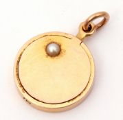 15ct stamped circular hinged locket highlighted with a small split seed pearl, verso engraved