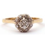 Diamond cluster ring featuring 4 small circular diamonds, raised above a small diamond surround,