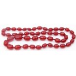Vintage cherry amber bead necklace, a single row of graduated drum shaped beads, 1.5cm to 2.5cm, g/w