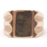 Large 9ct gold gent's signet ring, the plain polished rectangular panel raised between carved and