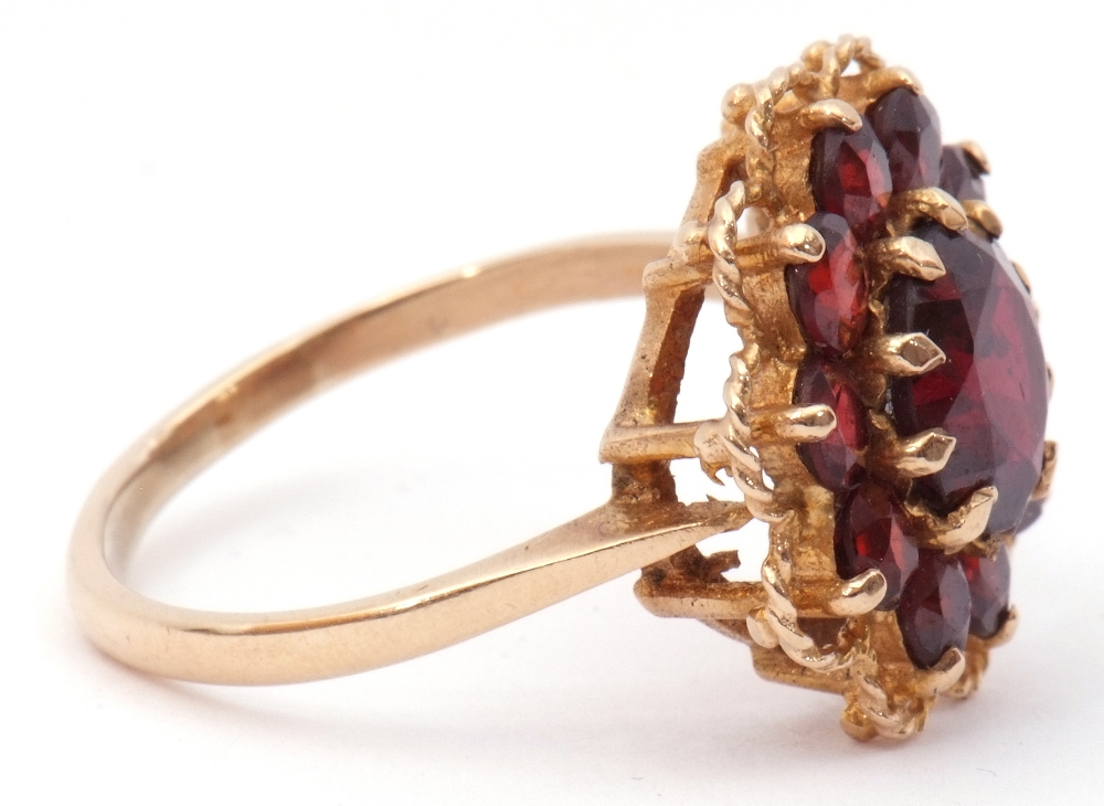 9ct gold garnet cluster ring, the central faceted round garnet within a small garnet surround, - Image 5 of 7