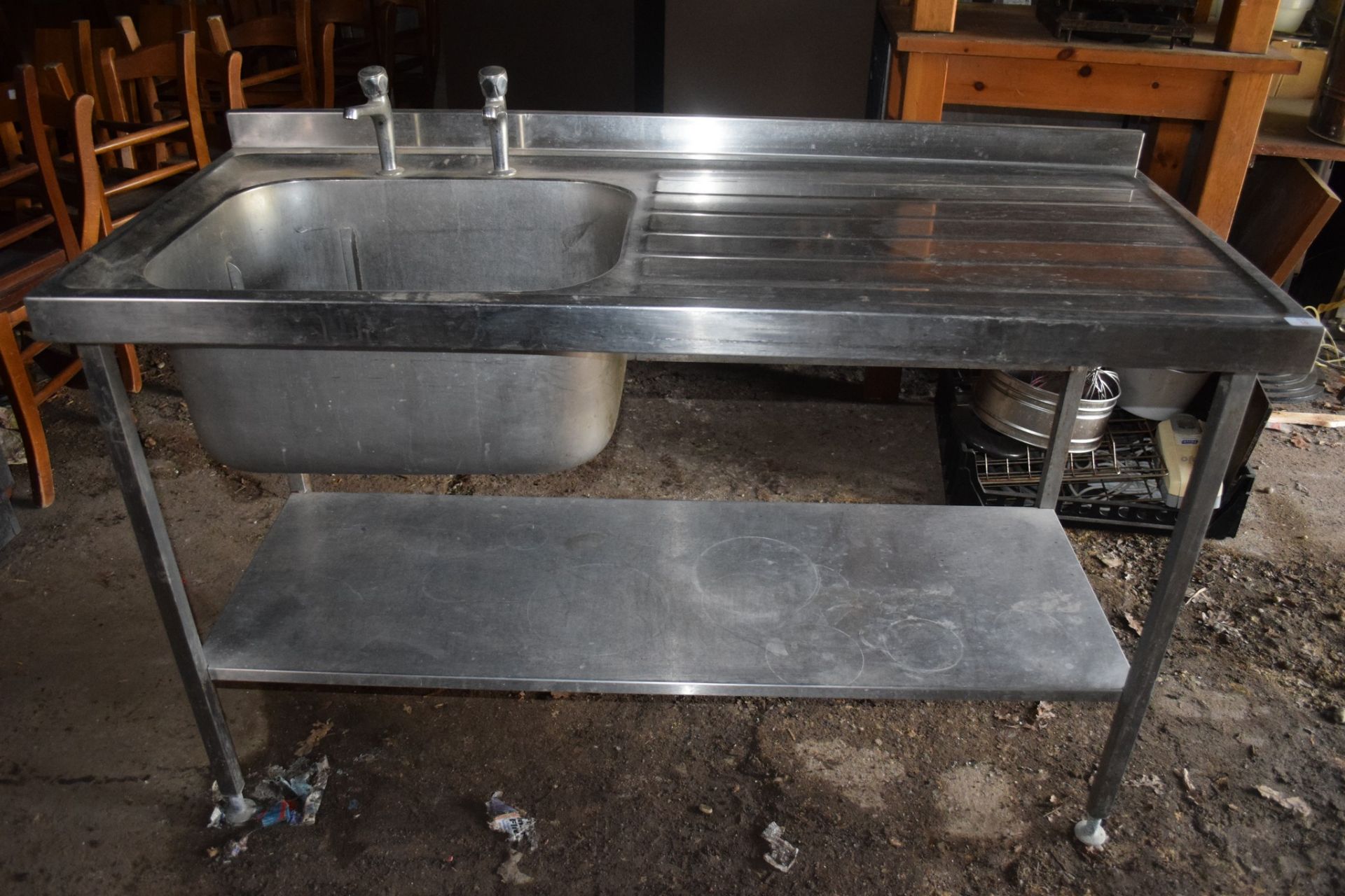 Single drainer large stainless steel Sink, on stand with shelf beneath.