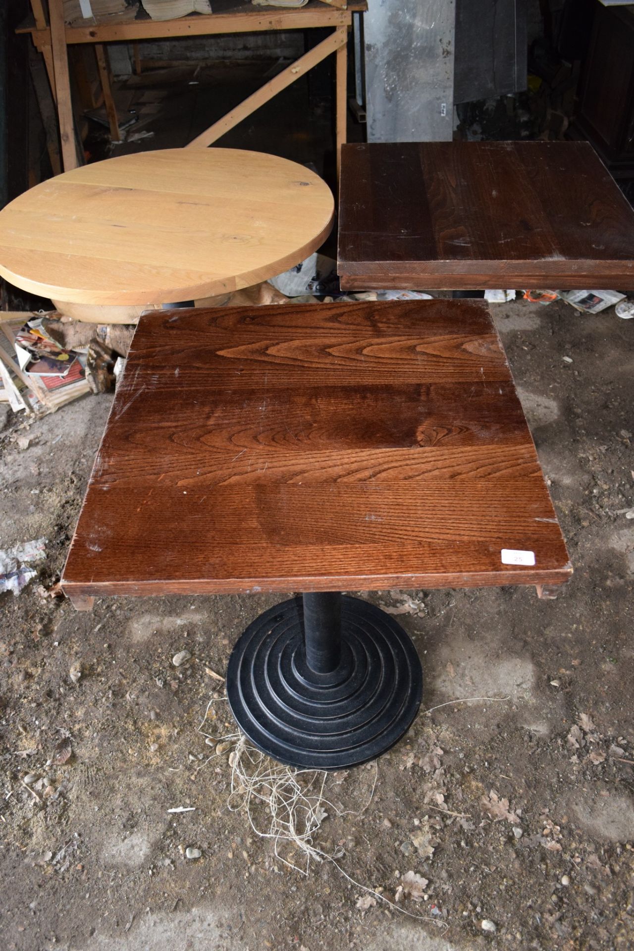 Three Bar or Bistro tables (two square and one circular), with matching metal column supports.