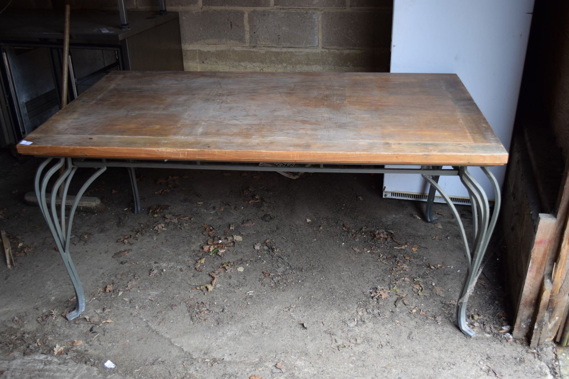 Large rectangular Dining Table, with ornate metal legs and moulding.