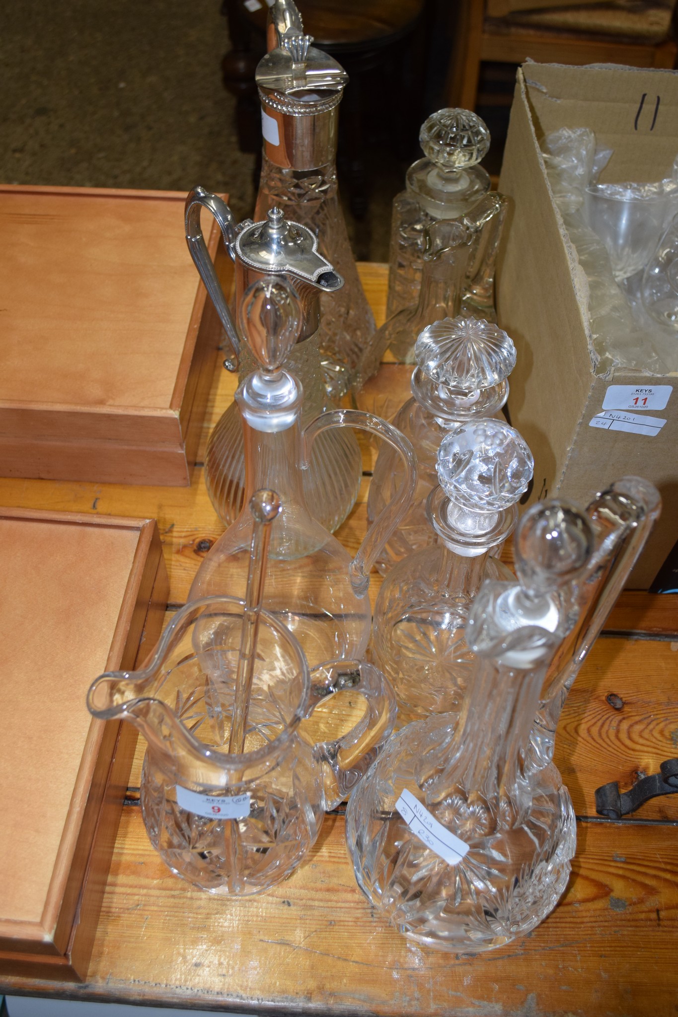 GROUP OF CUT GLASS WARES INCLUDING TWO PLATED CLARET JUGS, VARIOUS DECANTERS ETC