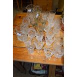 QUANTITY OF CUT GLASS WARES INCLUDING WINE GLASSES AND TWO JUGS