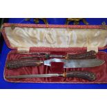 CASED SET OF A CARVING KNIFE AND FORK AND A SHARPENER WITH BONE HANDLES