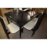 BLACK LACQUERED DINING SUITE OF TABLE AND SIX CHAIRS