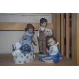 GROUP OF LLADRO FIGURES INCLUDING A BOY AND A GIRL AND TWO PUPPIES IN A BASKET