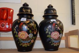 TWO VASES AND COVERS, THE BLACK GROUND WITH PEACOCK DECORATION