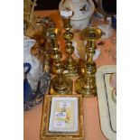 GROUP OF THREE PRINTS AND THREE BRASS CANDLESTICKS