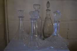 GROUP OF FIVE CUT GLASS DECANTERS AND STOPPERS