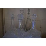 GROUP OF FIVE CUT GLASS DECANTERS AND STOPPERS