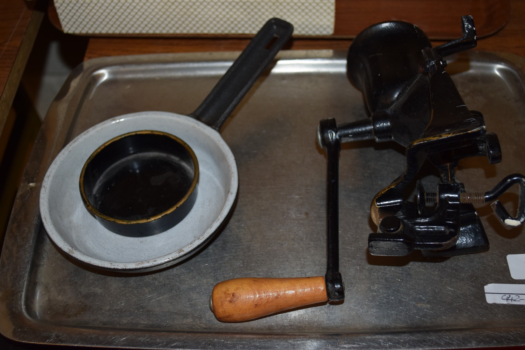 OLD MINCING MACHINE WITH WOODEN HANDLE AND WHITE METAL TRAY