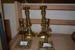 TWO PAIRS OF BRASS CANDLESTICKS