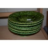 GROUP OF GREEN POTTERY PLATES MODELLED IN RELIEF WITH LEAVES