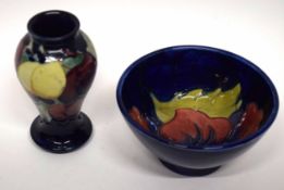 Small Moorcroft vase with Plum pattern, together with a further small Moorcroft vase, the blue