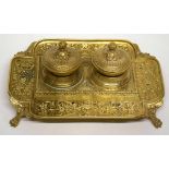 Gilt brass inkwell raised on four lion paw feet with gilt scroll work