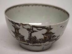 Lowestoft porcelain tea bowl decorated with a sepia pattern of pagodas with wavy line to interior