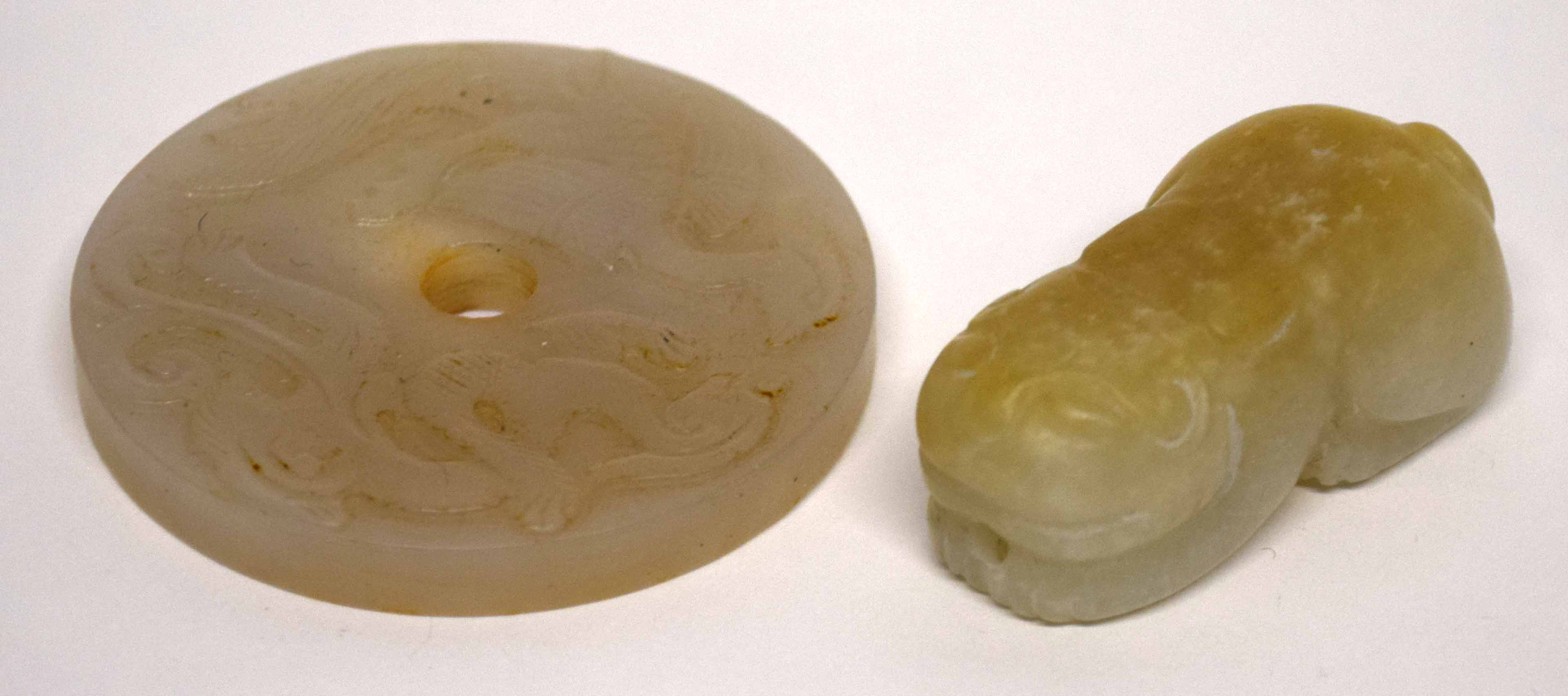 Chinese jade model of a cat, the white jade with russet occlusions, together with a circular disc