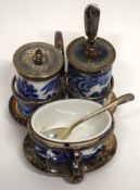 Cruet set and stand with a blue and white design by Davenport including a small silver mustard spoon