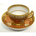 Early 19th century Coalport cup and saucer with a gilt design on salmon ground, pattern number