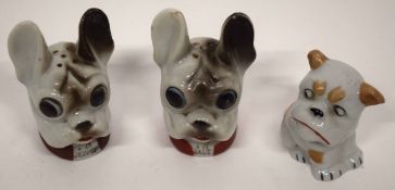 Box containing three Continental porcelain cruets modelled as dogs heads