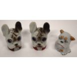 Box containing three Continental porcelain cruets modelled as dogs heads