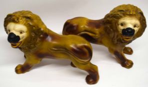 Two large pottery models of lions, 35cm long
