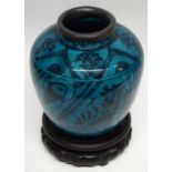 Large Persian pottery globular vase with metal rim, the vase decorated with a fish design on green