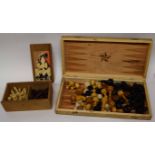Wooden box containing a wooden chess set and counters, marked for backgammon and chess