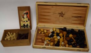 Wooden box containing a wooden chess set and counters, marked for backgammon and chess