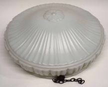 Plastic box containing large white glass shade