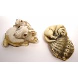 Two finely carved netsuke, in the form of a pair of rabbits