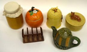 Group of butter tubs, jam jars and covers, one shaped as an orange, another jar and cover with