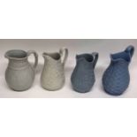 Group of four mid-19th century pottery jugs all with moulded designs (4), tallest 22cm