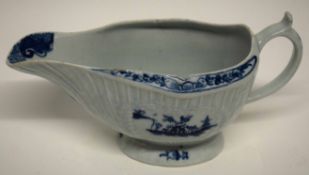 Lowestoft porcelain sauce boat, blue and white design of a fisherman with floral sprig to interior